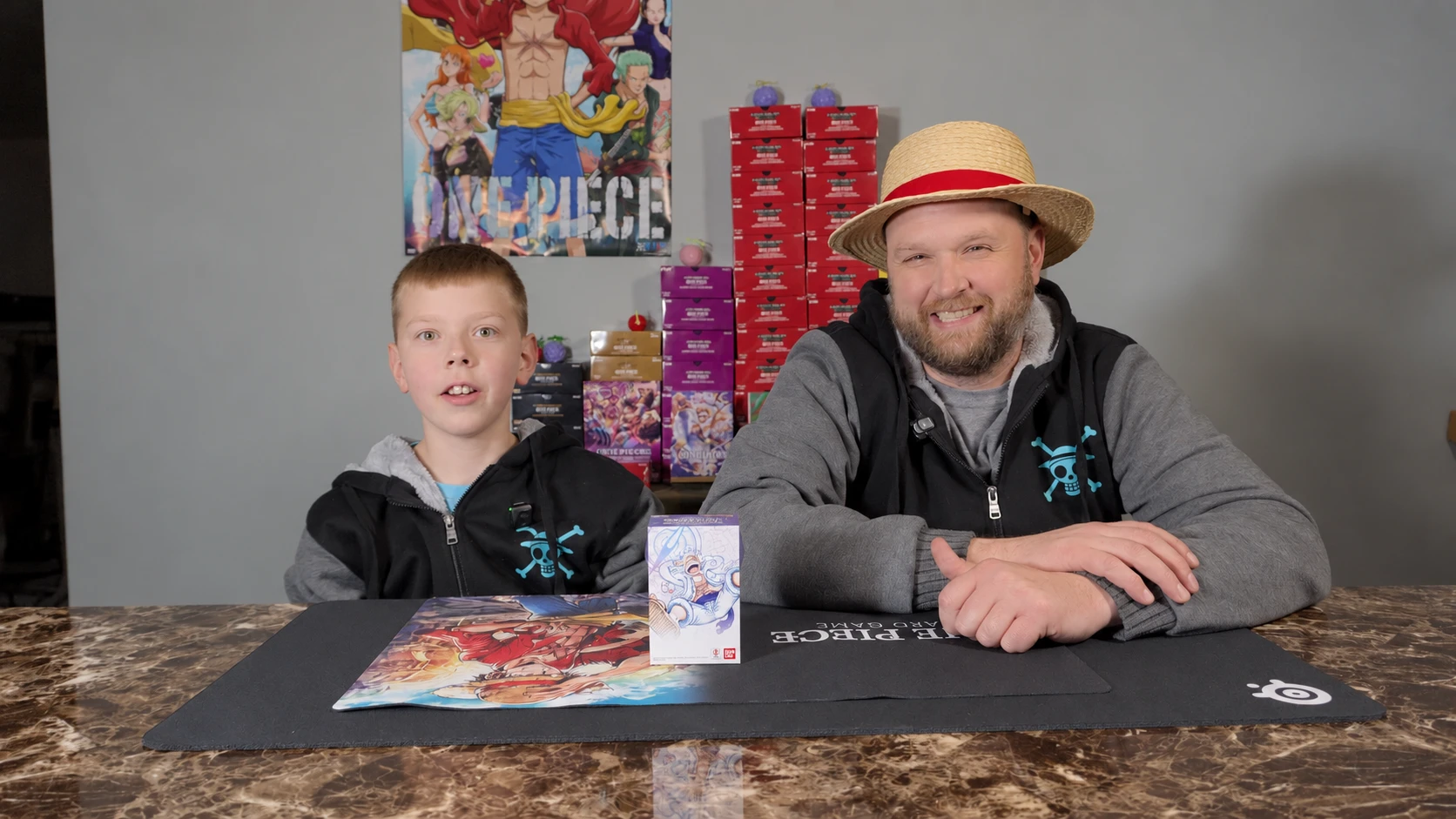 Hudson and Mat together at their One Piece card-opening table